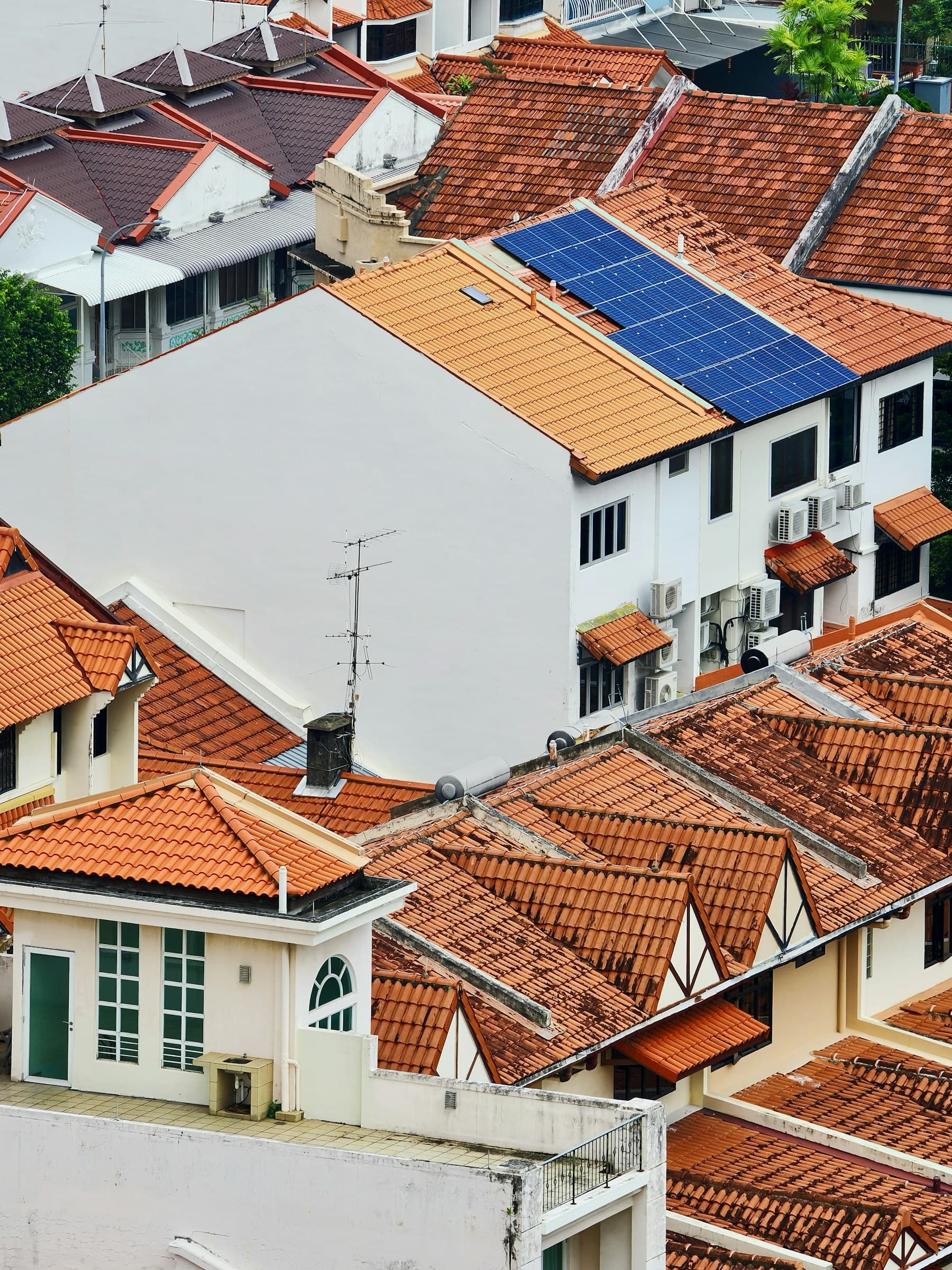 Multiple Karachi rooftops with visible solar panel coverage.
