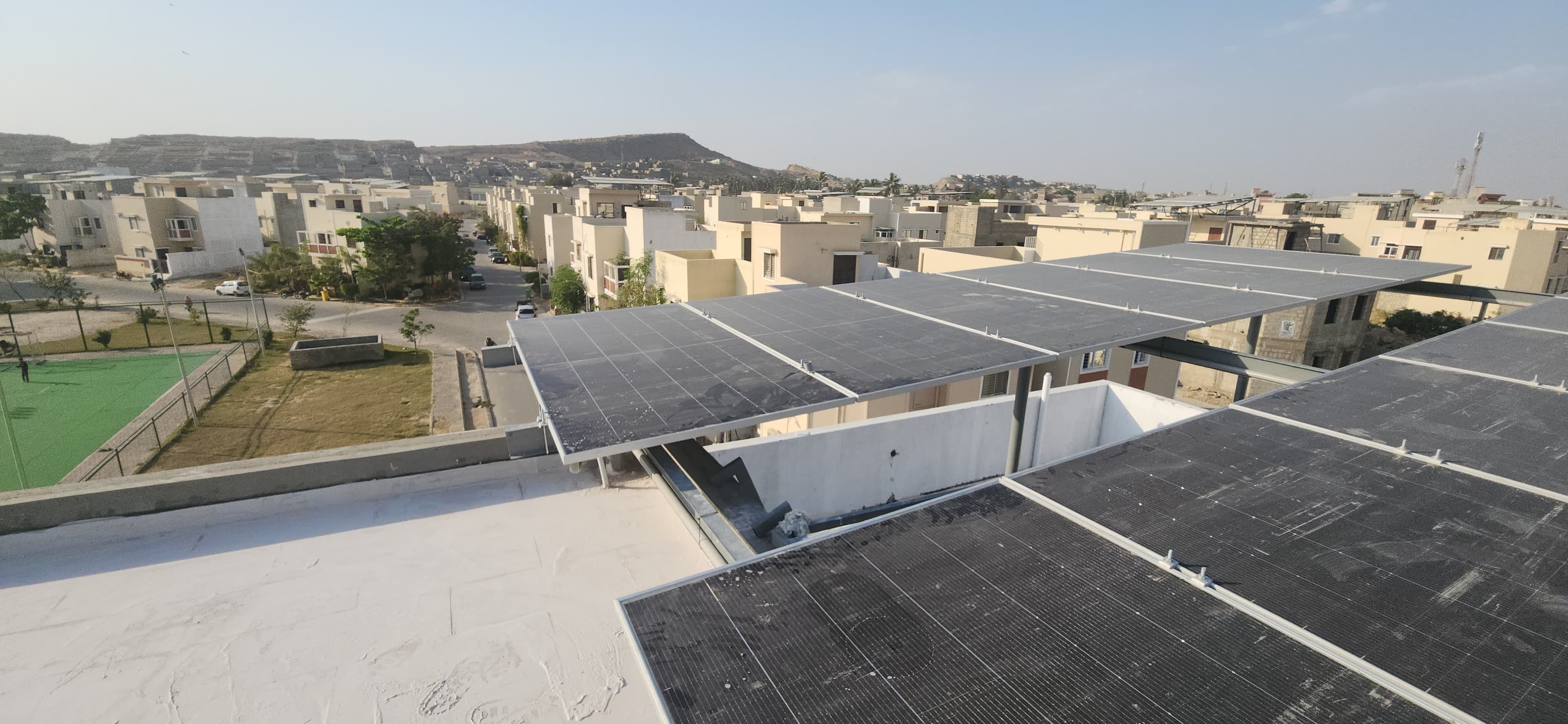 Completed rooftop solar system with neighborhood context in Karachi.