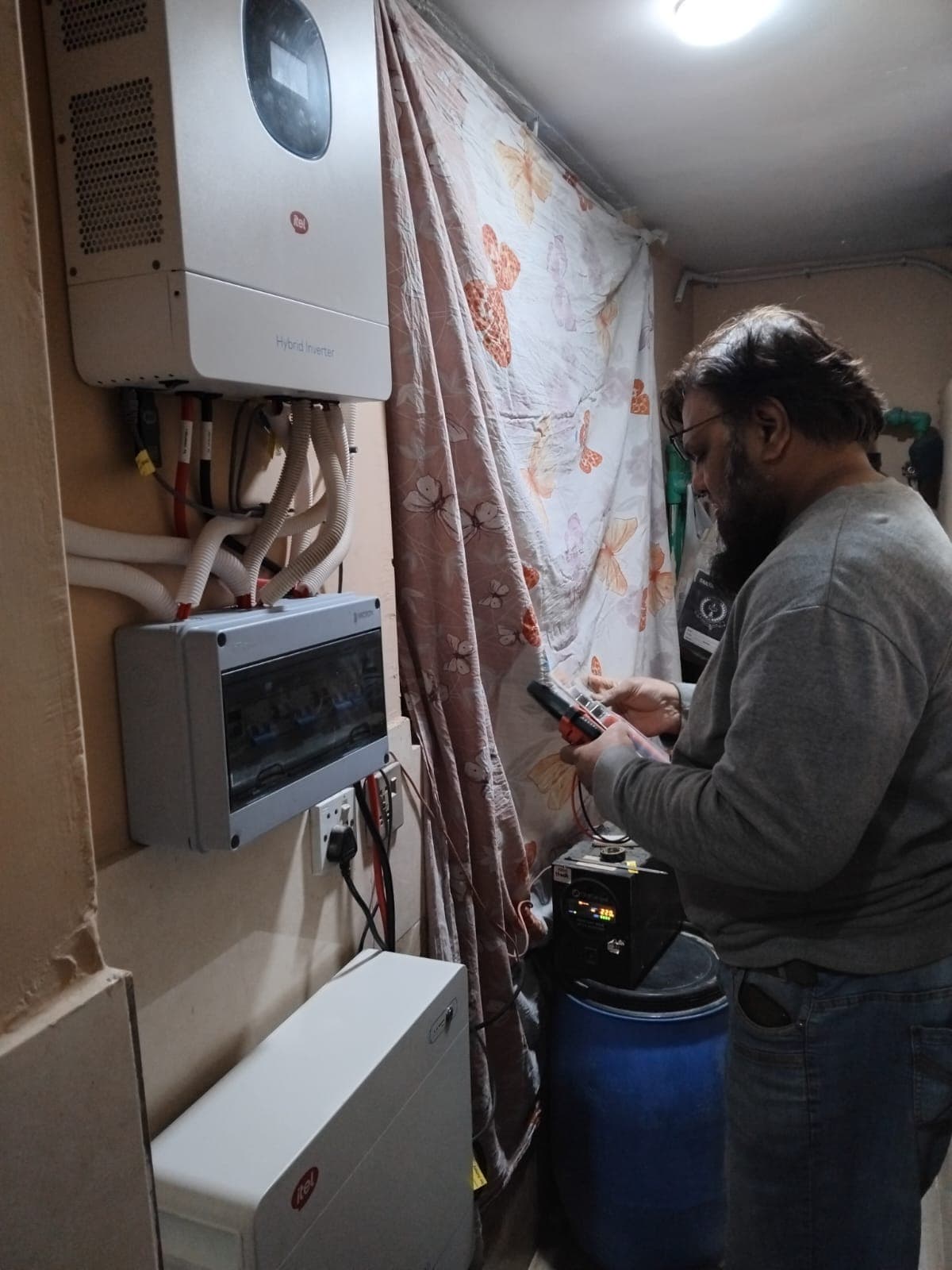 Hybrid inverter and battery setup during electrical testing.